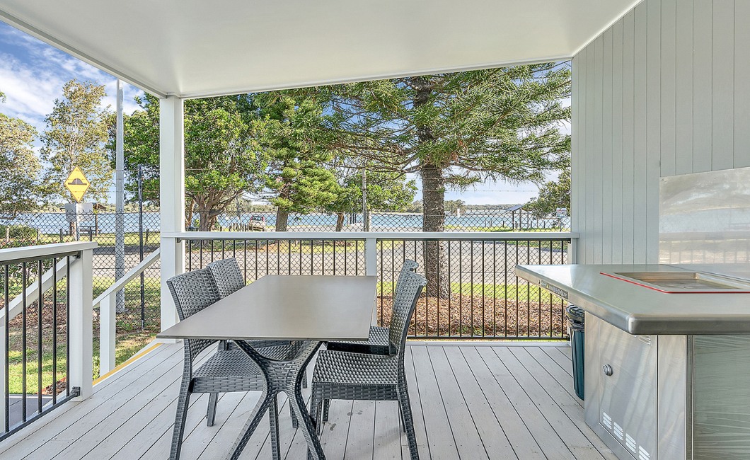 The deck of a comfortable waterside cabin used for respite stays